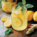 Lemon bomb drink for weight loss in glass with lemon and ginger